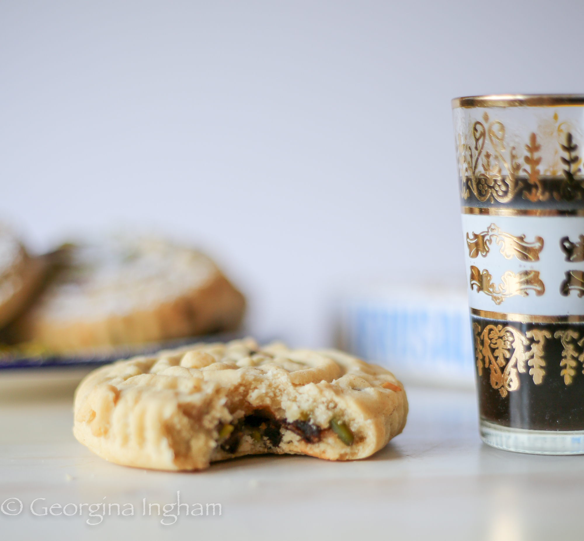 Close-up interior shot of a Ma'amoul cookie, showing its soft, spiced filling inside a delicate pastry shell
